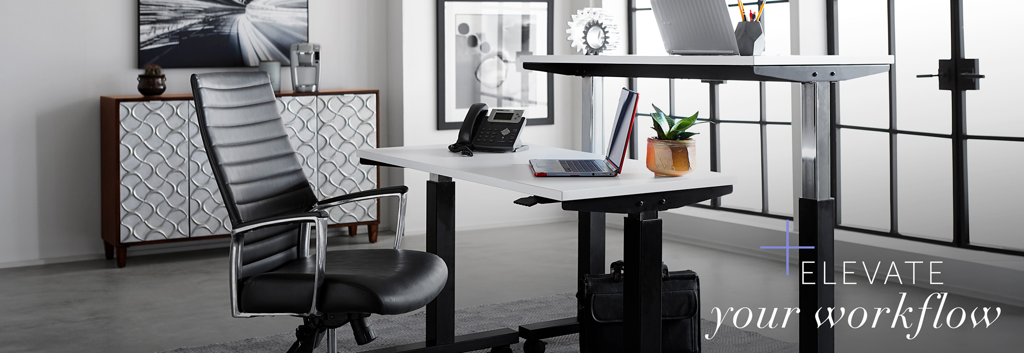 Office with rented standing desks with words ‘elevate your workflow”